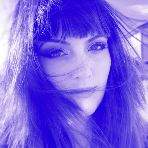 A close up image of Meredith, in a blue duotone format.